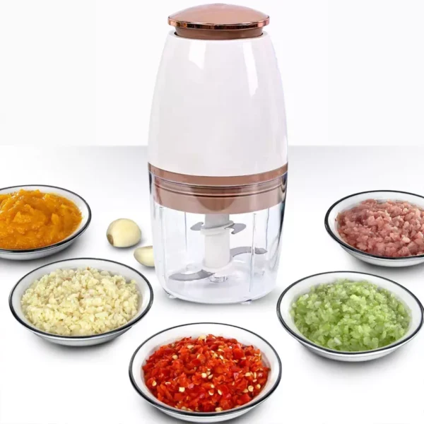 Electric food processor grinding meat inside transparent bowl